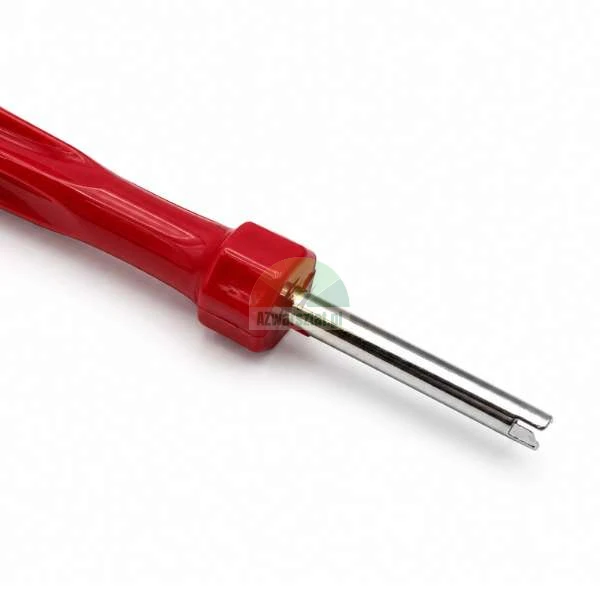 Valve core removal tool with a red plastic handle and a metal tip, isolated on a white background.