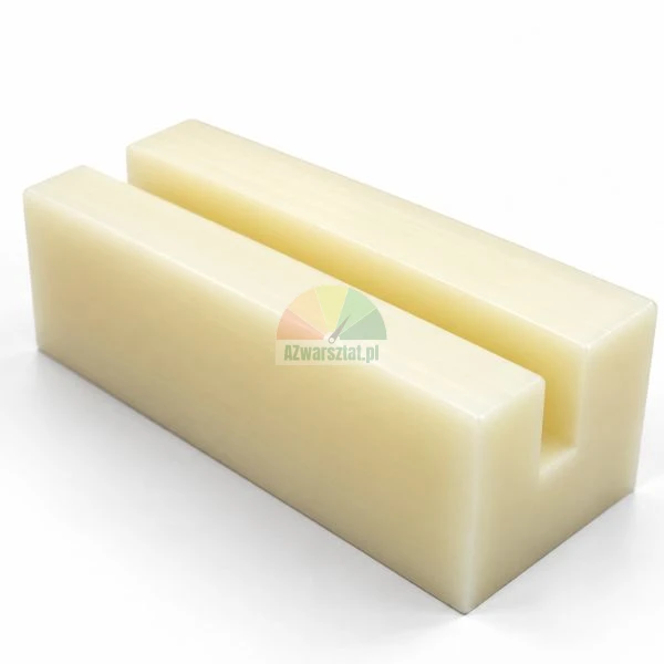 Rectangular off-white plastic block with a central longitudinal U-groove on a white background