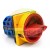 Industrial emergency stop rotary switch with a red handle, yellow frame, and blue terminal block