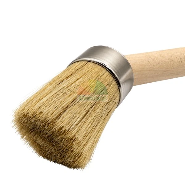 Round paint brush with natural light bristles, metal ferrule, and wooden handle on a white background