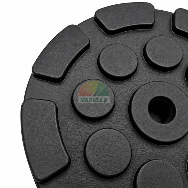 Close-up of a black composite weight plate with textured surface and center hole.